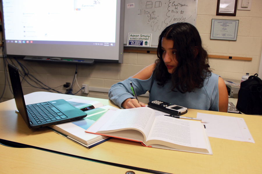 Testing Takes a Turn: Elisabet Ortiz studies at the table for the ACT.
