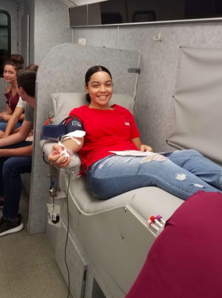 Student gets blood drawn inside a Lee Health donation bus.