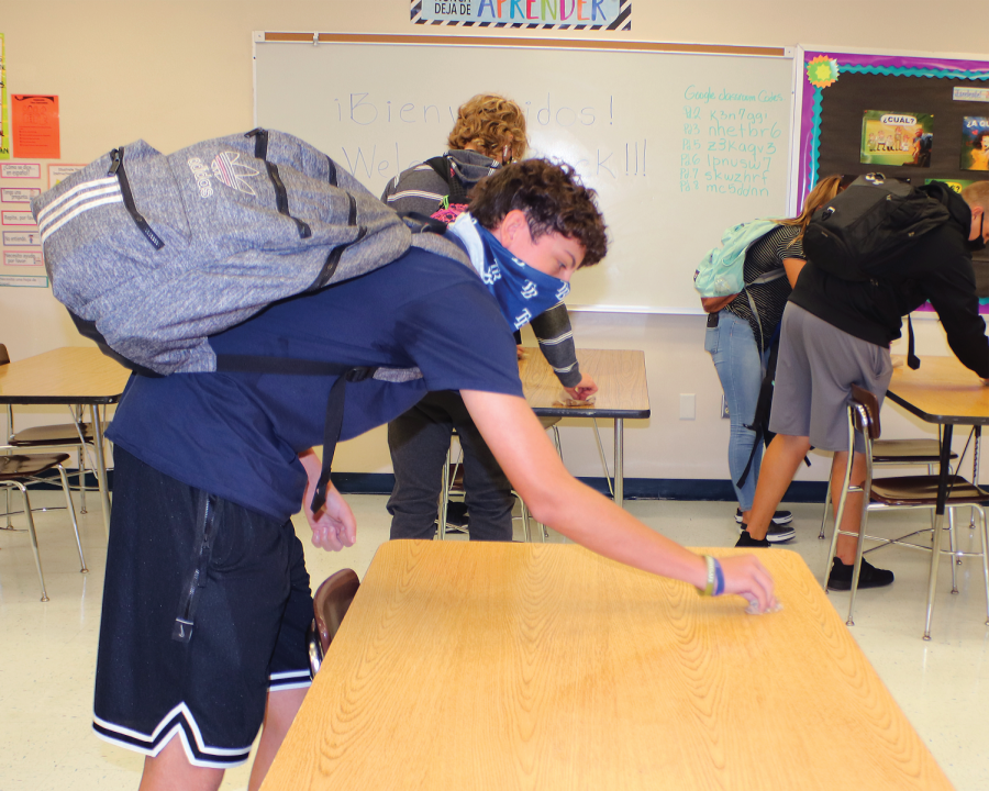 Students follow contact tracing procedures by sitting in their socially distanced assigned seats and cleaning them at the end of class.