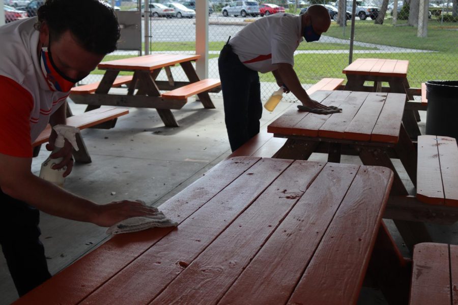 Cape High administration cleans tables during lunch periods.