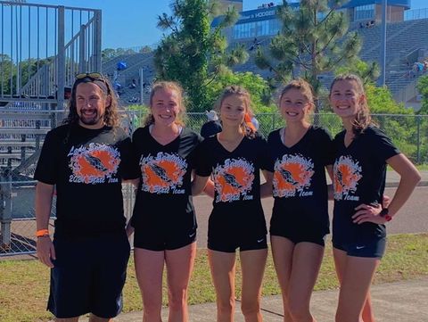 Coach Robert Berkey, Lucy Casto-Waters, Bella Sibbrell, Jenny Jacoby, and Natalee Jones on May 7th at a states track meet located at the University of North Florida 